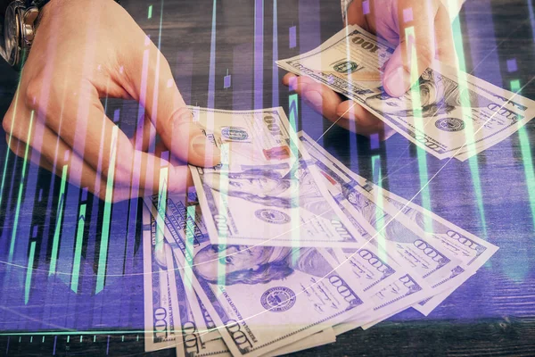 Multi eksponering af finansielle graf tegning hologram og USA dollars regninger og mand hænder. Analysekoncept. - Stock-foto