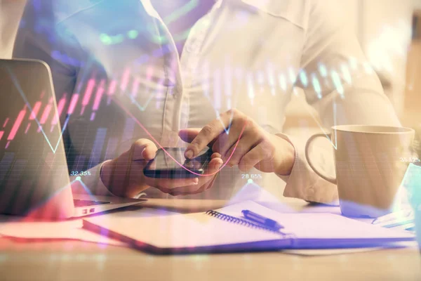 Double exposure of forex chart sketch hologram and woman holding and using a mobile device. Financial market concept.