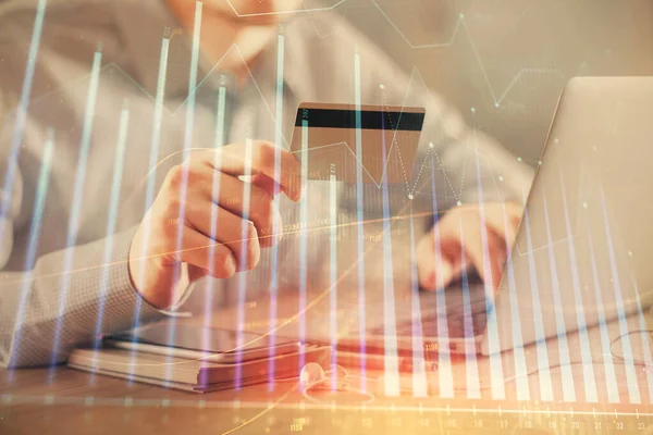 Double exposure of man hands holding a credit card and Forex graph drawing. Stock trading and digital fintech in Internet E-commerce concept. — Stock Photo, Image