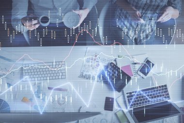 Birlikte çalışan kadın ve erkeğin çifte pozu ve finansal grafik hologramı çizimi. Pazar analizi konsepti. Bilgisayar arkaplanı. Üst Görünüm.