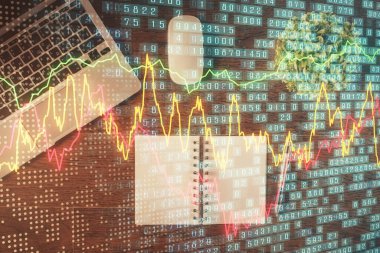 Borsa grafiği ve masa arkasındaki en üst görünüm bilgisayarı. Çifte maruziyet. Finansal eğitim kavramı.