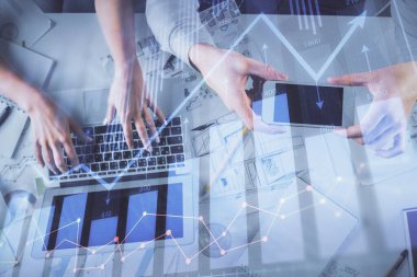Kadın ve erkeğin birlikte çalıştığı çoklu pozlama ve grafik hologramı çizimi. Finansal analiz konsepti. Bilgisayar arkaplanı. Üst Görünüm.