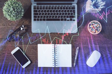 Borsa grafiği ve masa arkasındaki en üst görünüm bilgisayarı. Çoklu maruz kalma. Finansal eğitim kavramı.