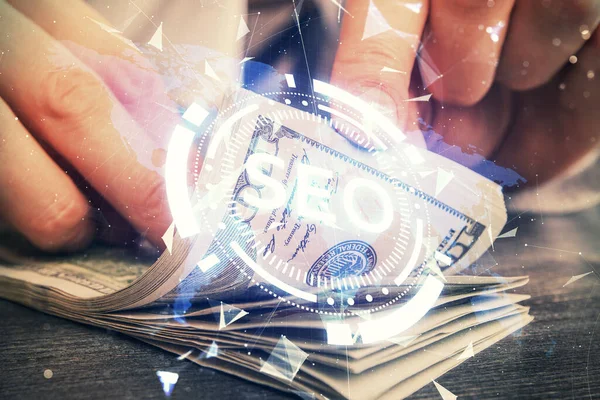 Multi exposición de seo dibujo holograma y nosotros dólares billetes y manos de hombre. — Foto de Stock