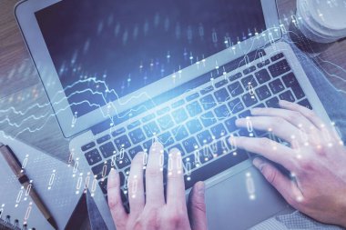 Erkeklerin ellerinin bilgisayar klavyesini ve ön grafik hologram çizimlerini yazarken çifte pozlama. Üst Manzara. Finans piyasası kavramı.