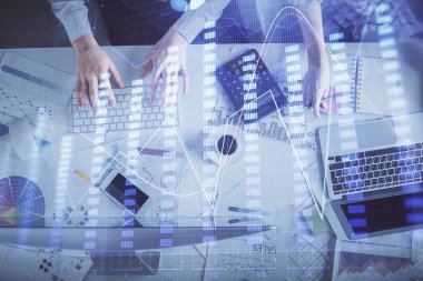 Birlikte çalışan kadın ve erkeğin çifte pozu ve finansal grafik hologramı çizimi. Pazar analizi konsepti. Bilgisayar arkaplanı. Üst Görünüm.