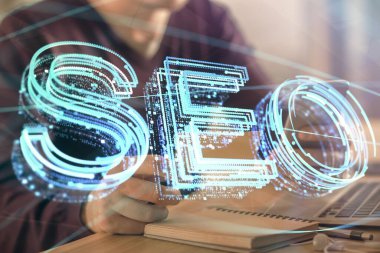 Erkeklerin el ele tutuşup dijital bir cihaz ve seo çizimi kullanırken birden fazla pozlama. arama optimizasyonu kavramı.