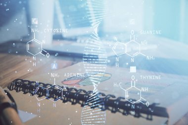 DNA çizimi ve açık defter arkaplanı olan bir masa. Eğitim kavramı