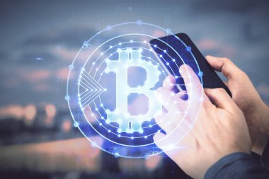 Bir adamın elini tutarken ve telefon ve kripto para birimi engelleme teması kullanırken çift pozlama.