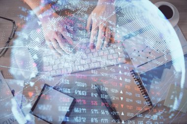 İnsan elinin bilgisayar klavyesi ve iş temalı hologram çiziminin üzerine iki kez yazı yazması. Üst Manzara. Finans piyasası kavramı.