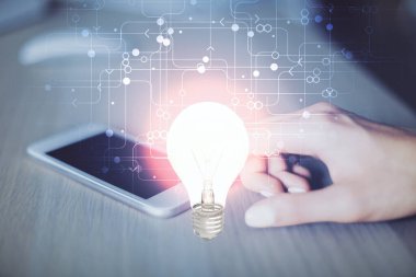 Ampul hologramına çift pozlama ve mobil cihaz kullanan bir kadın. Fikir kavramı.