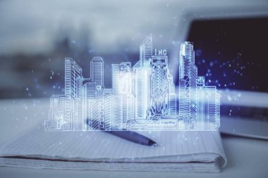 Kasaba çizimleri ve açık defter geçmişi olan bir masa. Akıllı şehir kavramı