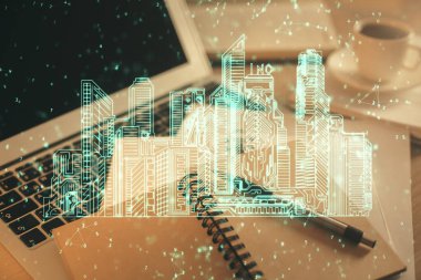 Masa arkasında kahve ve eşyalar olan iki kat bina çizimi ve masaüstü görüntüsü. Akıllı şehir kavramı