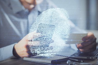 Dijital bir cihaz ve parmak izi hologramı kullanarak insanın elini tutarken çift pozlama. Güvenlik kavramı.