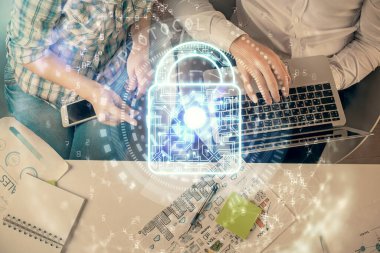 Kadın ve erkeğin birlikte çalışıp hologram çizimlerini kilitlerken çift pozlama. Güvenlik kavramı. Bilgisayar arkaplanı. Üst Görünüm.