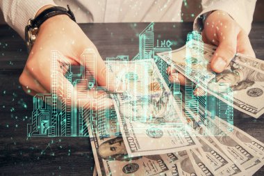 Hologram, Amerikan doları ve insan eli çeken binaların çoklu pozları..