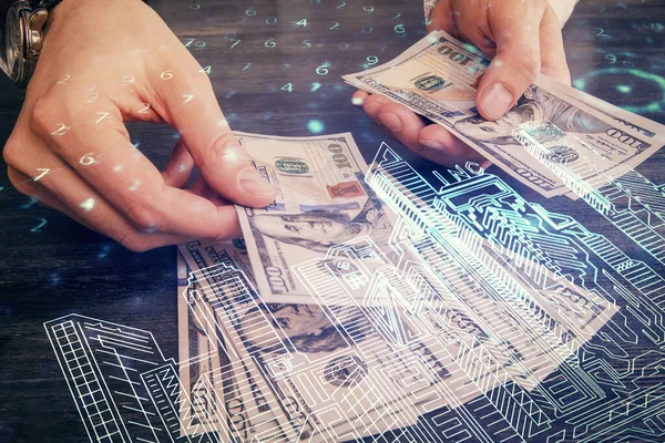 Multi exposure of buildings drawing hologram and USA dollars bills and man hands.
