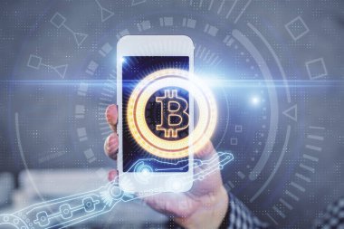 Bir adamın elini tutarken ve telefon ve kripto para birimi engelleme teması kullanırken çift pozlama.