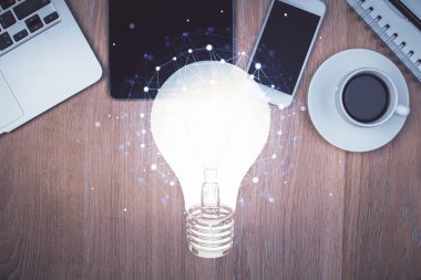 Ampulü telefonla masanın üzerine çizerken çift pozlama. Üst Manzara. Fikir kavramı.