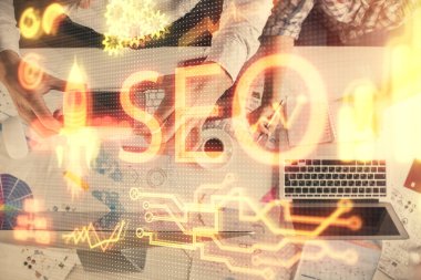 SEO hologram çizimleri ve birlikte çalışan kadın ve erkeğin çifte pozu. Arama motoru konsepti. Bilgisayar arkaplanı. Üst Görünüm.