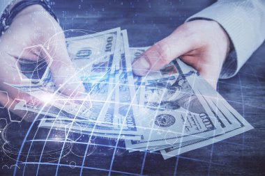 Dünya haritasının iki katına çıkarılması hologram, dolar banknotları ve insan eli..