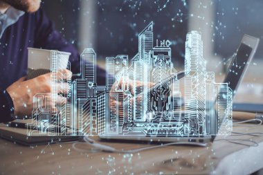 Dijital bir cihaz ve şehir çizimi kullanarak insanın ellerini tutarken çift pozlama.