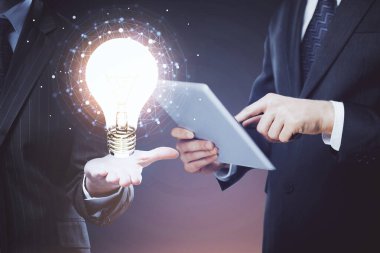 Dijital bir cihaz ve ampul hologram çizimi kullanarak insanın ellerini tutarken çift pozlama. Fikir kavramı.