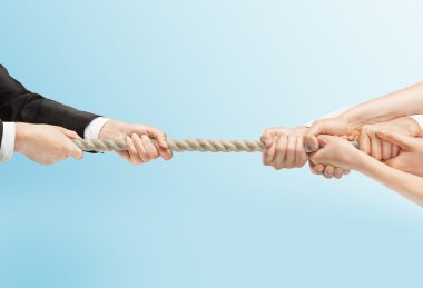 people hand pulling rope