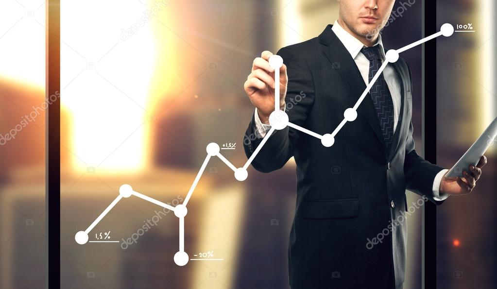 businessman drawing graph