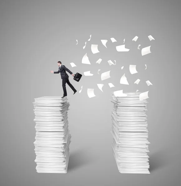 Man jumping from top papers — Stock Photo, Image