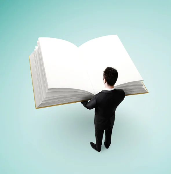 Businessman holding big book — Stock Photo, Image