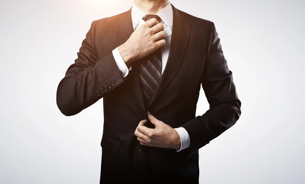 Businessman adjusts his tie — Stock Photo, Image