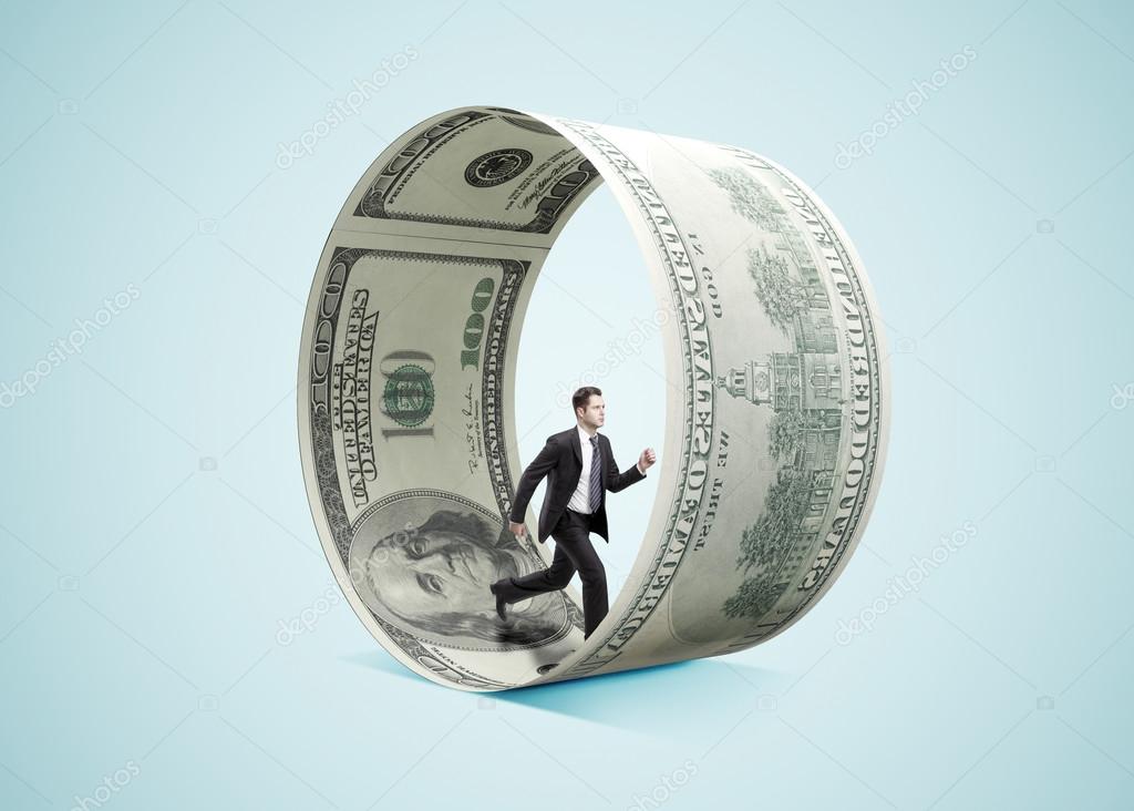 businessman running in money wheel