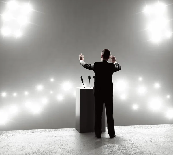 Businessman standing on podium — Stock Photo, Image