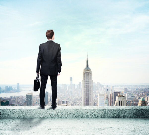 Businessman standing on roof