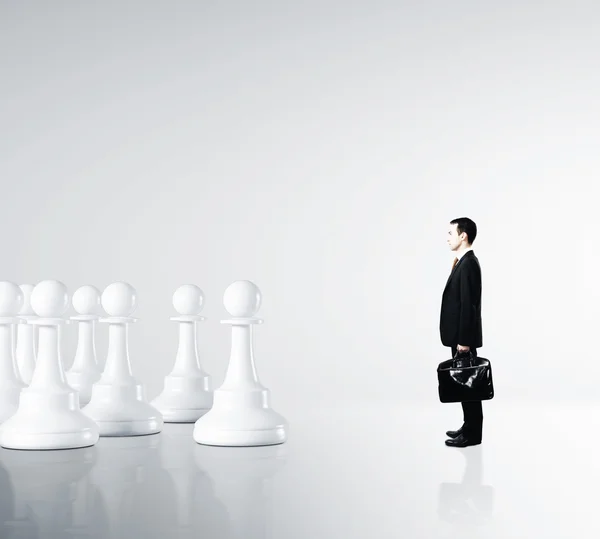 Businessman and pawns — Stock Photo, Image