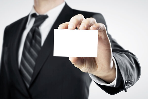businessman handing a blank business card