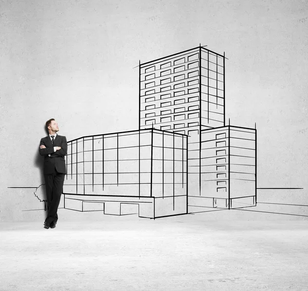 Businessman and drawing skyscraper — Stock Photo, Image