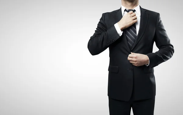 Businessman straightens his tie — Stock Photo, Image