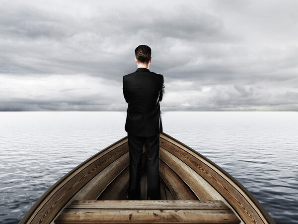 businessman standing on a boat