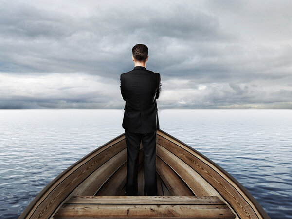 businessman standing on a boat