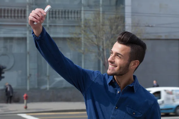 Young man using a smart phone — Stock Photo, Image
