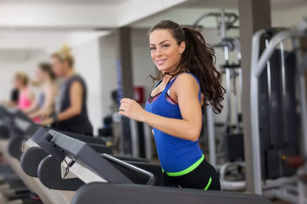 Beautiful brunette on a treadmill — Stock Photo, Image