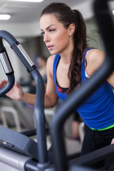 Jeune femme travaillant sur un stepper — Photo