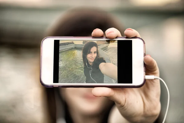 年轻女子正在用她的手机拍照 — 图库照片