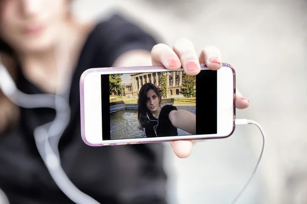 Young  woman taking a photo with her phone — Stock Photo, Image