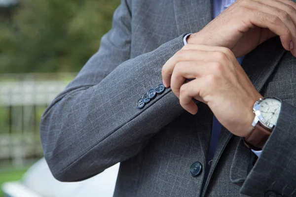 Elegante giovane uomo d'affari in smoking abbottonando la giacca — Foto Stock