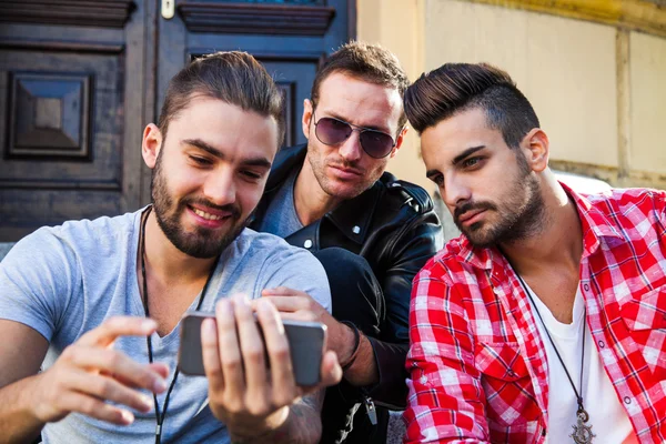 Jovens amigos hipster tendo em conjunto com telefone inteligente — Fotografia de Stock