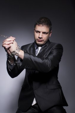 His hands are in chains