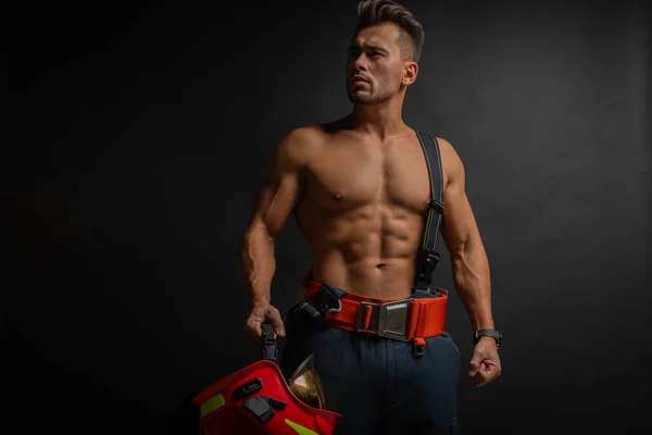 Portrait Muscular Handsome Firefighter Dark Background Holding Fire Helmet Looking — Stock Photo, Image